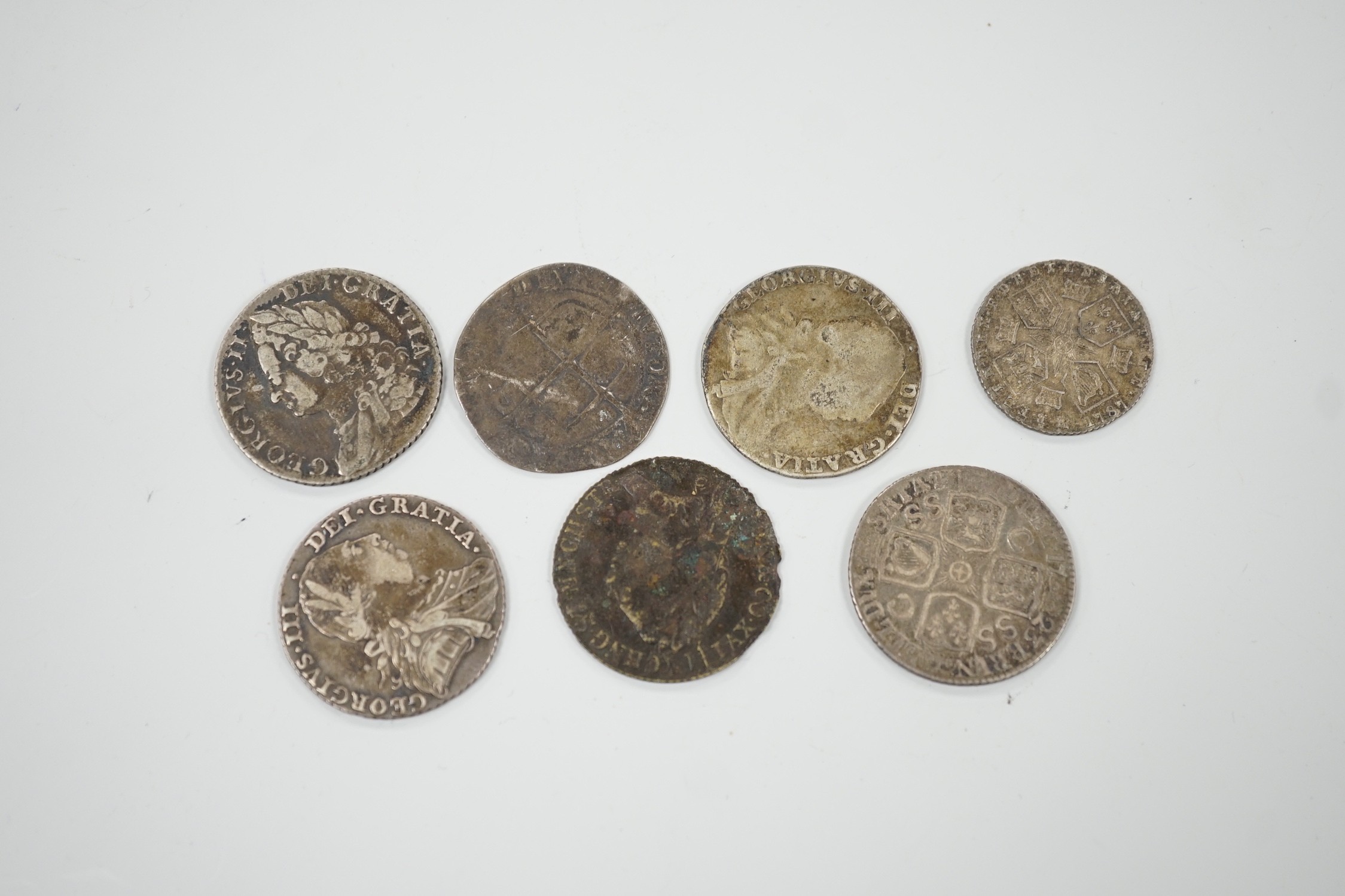 Four 18th century shillings, a sixpence an Elizabeth I coin and a token